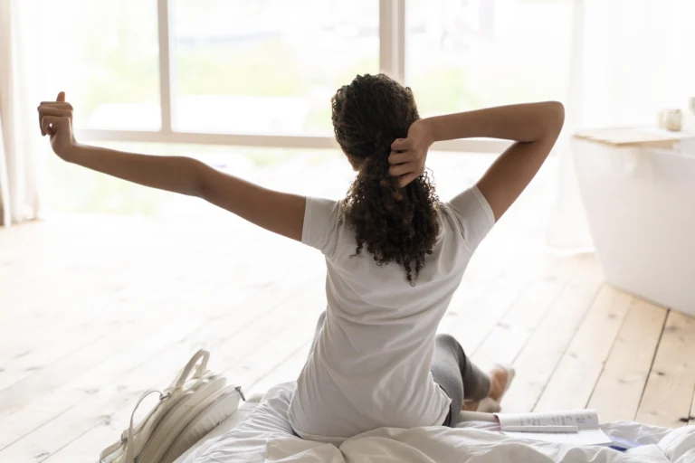 back-view-little-girl-stretching-after-good-sleep